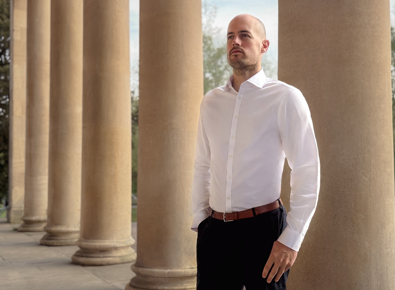 Phil Bennetts standing among the columns at Pittville Pump Room, Cheltenham.